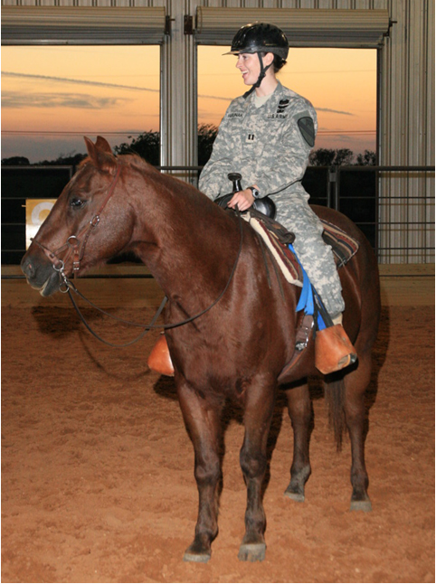 A military veteran participating in a therapeutic riding session.